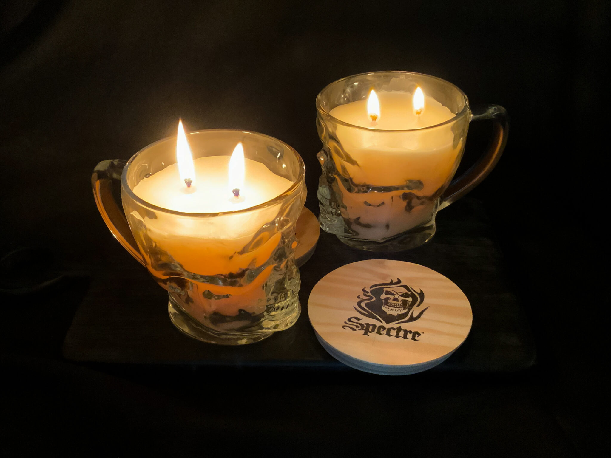 two skull mug candles, lit